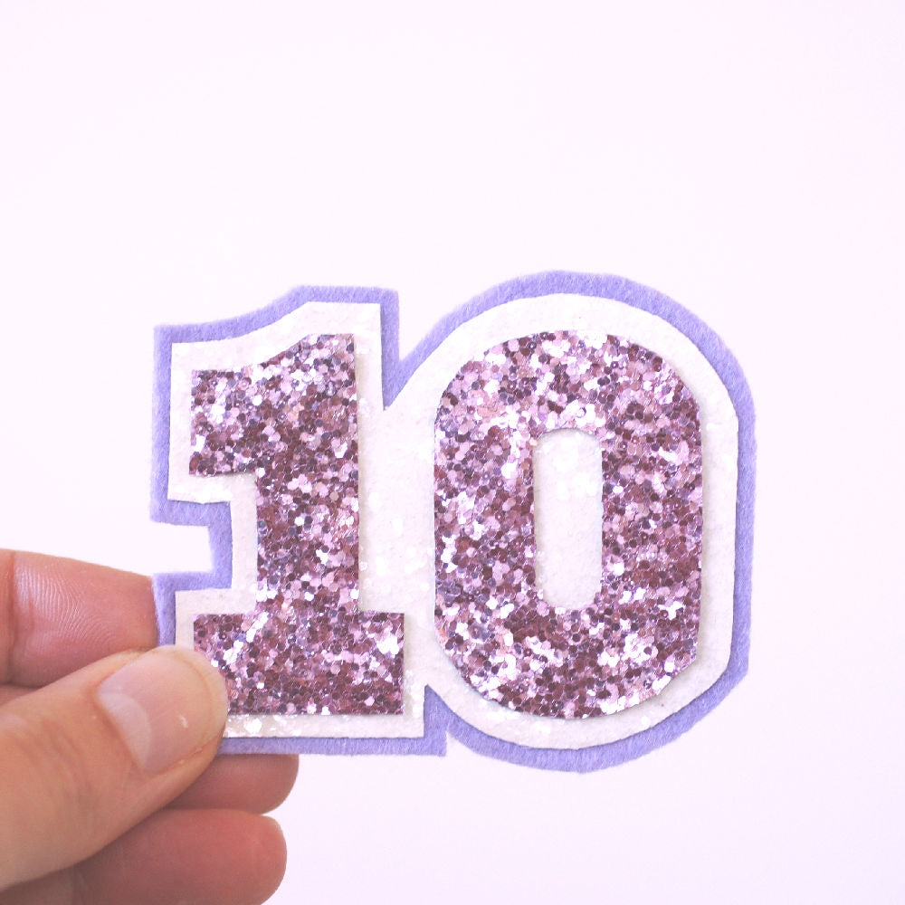 number birthday badge for a 10th birthday in pink and white glitter