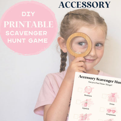 Girl holding a magnifying glass and a checklist page of a doll accessory scavenger hunt.. Text reads DIY printable scavenger hunt game - accessory theme. 