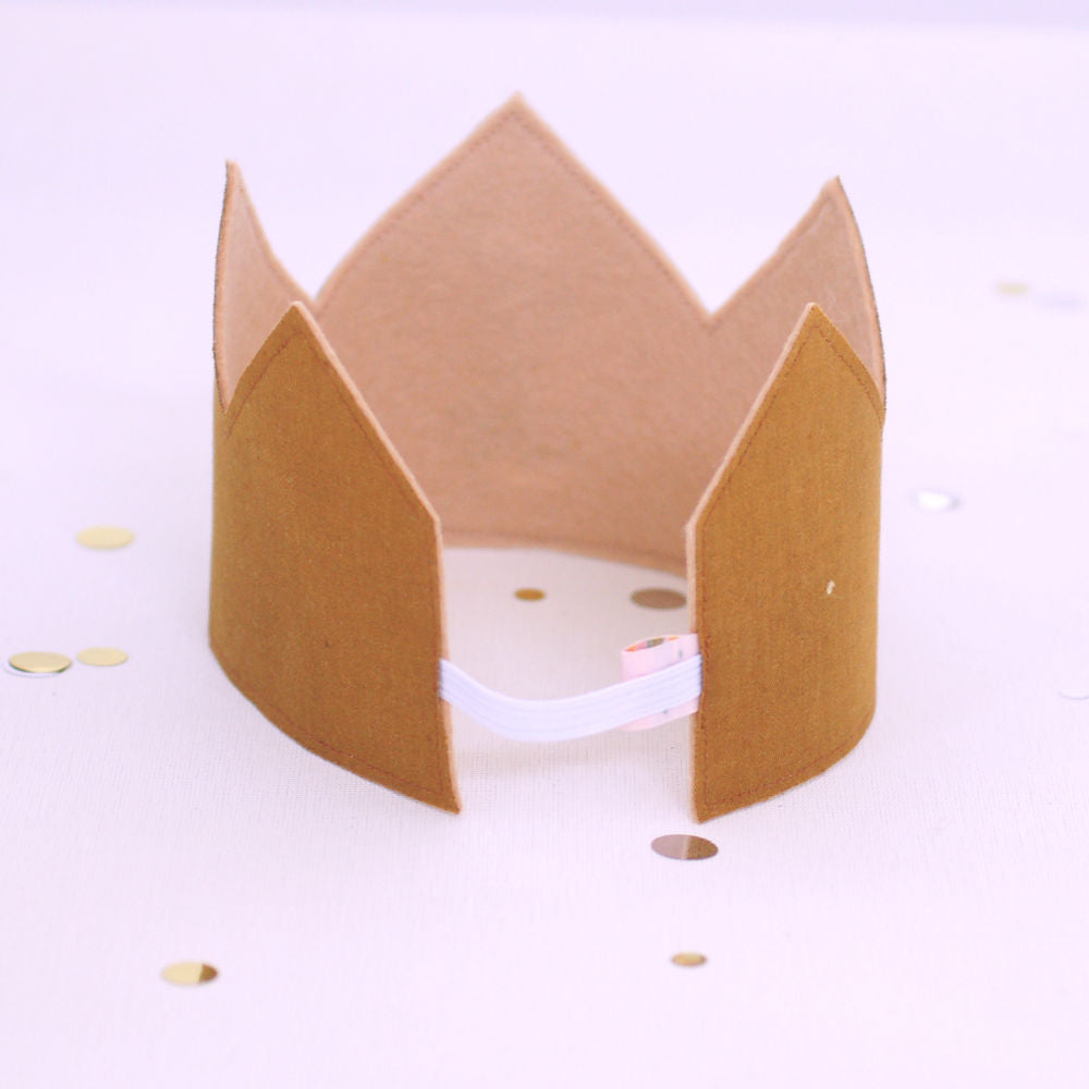 reverse view of a boys first birthday crown showing the tan felt backing, and elastic