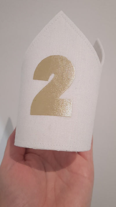 white linen 2nd birthday crown showing video of gold faux leather 2 detail on the front of the birthday crown
