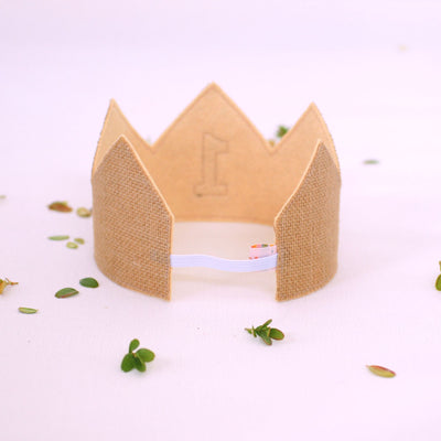 reverse view of the first birthday crown showing the tan felt backing and elastic for a comfortable fit