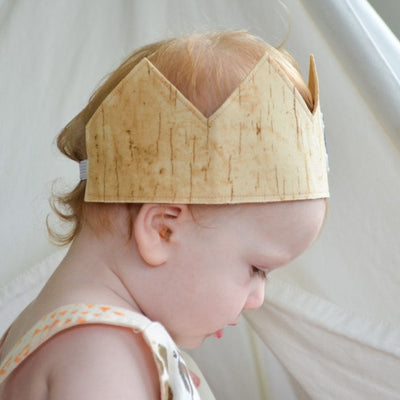 1 year old boy wearing a classic style 1st birthday crown to show fit on the head from a side view