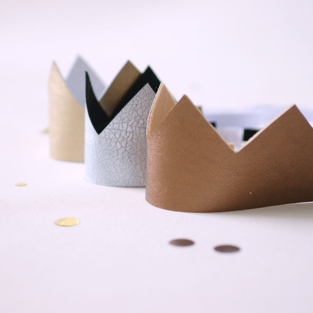 gold silver and bronze fabric crowns lined up in a row
